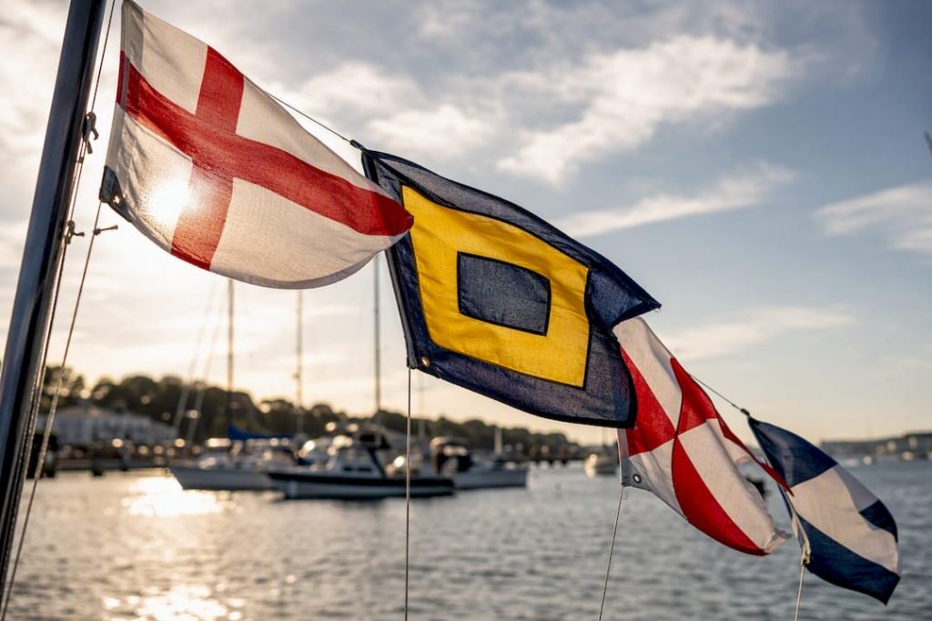 Nautical signal flags flying on ship mast